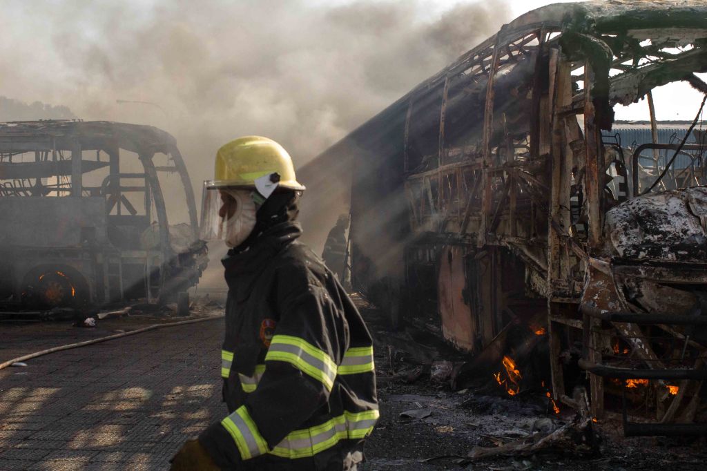 Johannesburg Emergency Management Services at the scene extinguish a fire, that affected three buses and two trucks at a bus depot in Fordsburg on Albertina Sisulu Road. 26 June 2015