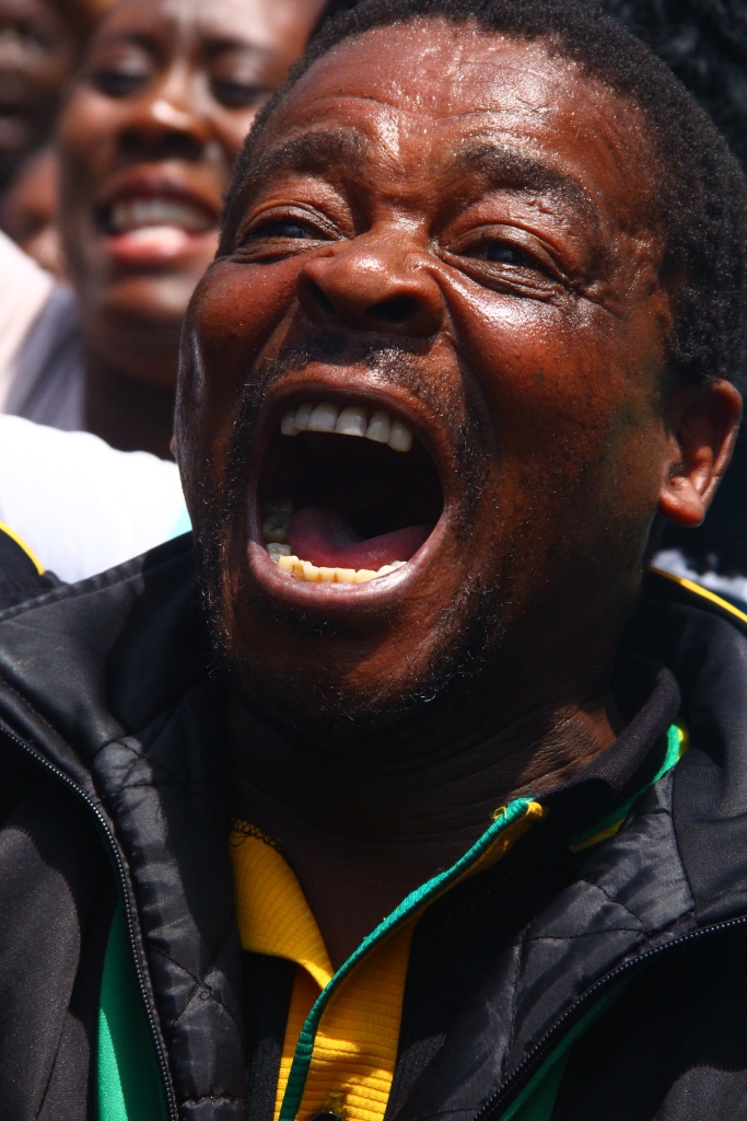 SOUTH AFRICA: A supporter of the African National Congress (ANC) sings and dances in the streets of Johannesburg outside the Gauteng Legislature 23 February 2015, after the State of the Province Address (SOPA) by Premier David Makhura. © JABULILE PEARL HLANZE